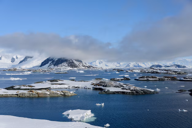 Snow-covered islands and mountains along a polar coastline