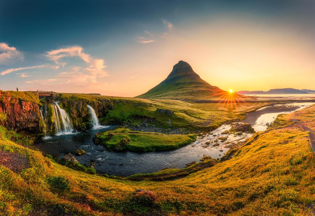 Kirkjufell mountain and waterfalls at sunrise in summer